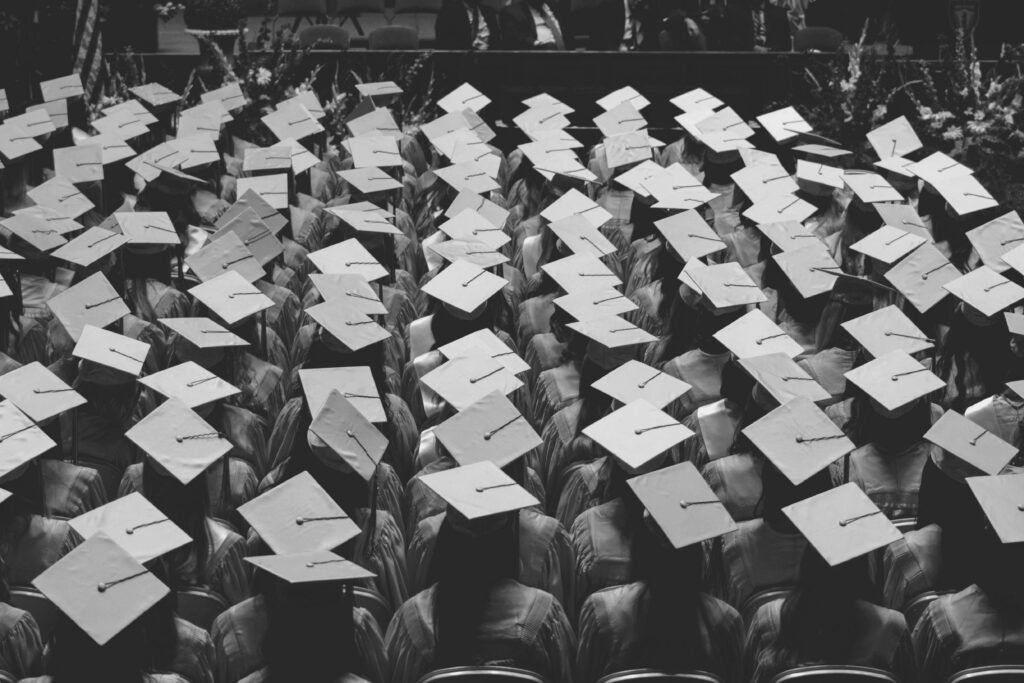 Graduates in mortarboards at a university graduation ceremony